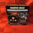 Sharper Image Shaped 12V Air Compressor For Roadside Inflation New. Price: $24.95.